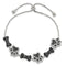 Elegant dog bone-themed bracelet with sparkling black and silver accents, perfect for stylish pet lovers.