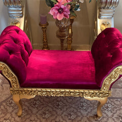 Luxurious small magenta velvet dog bed with ornate golden frame and accents, displayed elegantly in a chic room setting