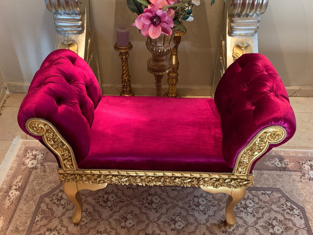 Luxurious small magenta velvet dog bed with ornate golden frame and accents, displayed elegantly in a chic room setting