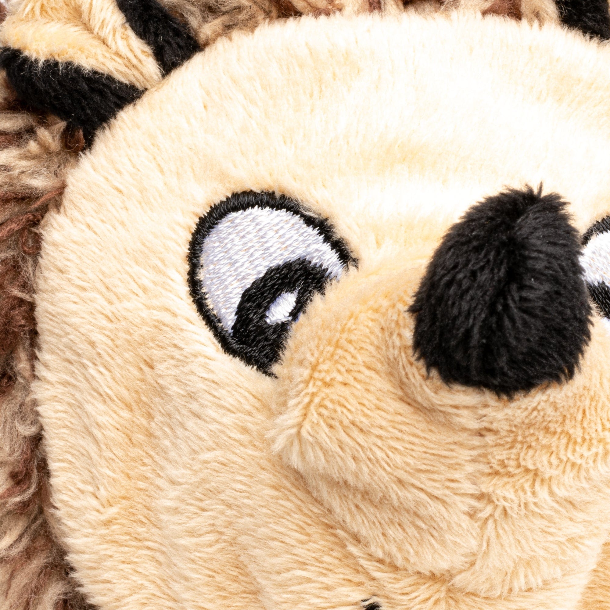 close up of Hedgehog faball® with big cartoon eyes, and upturned black nose and a beige face